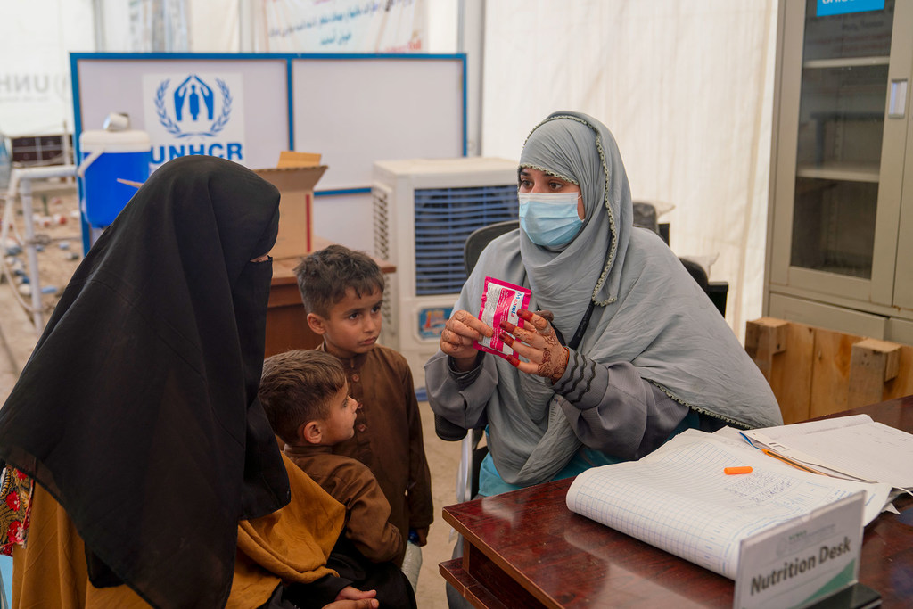 At a UNHCR centre near the Torkham border, an Afghan family recently returned from Pakistan receives a health consultation.
